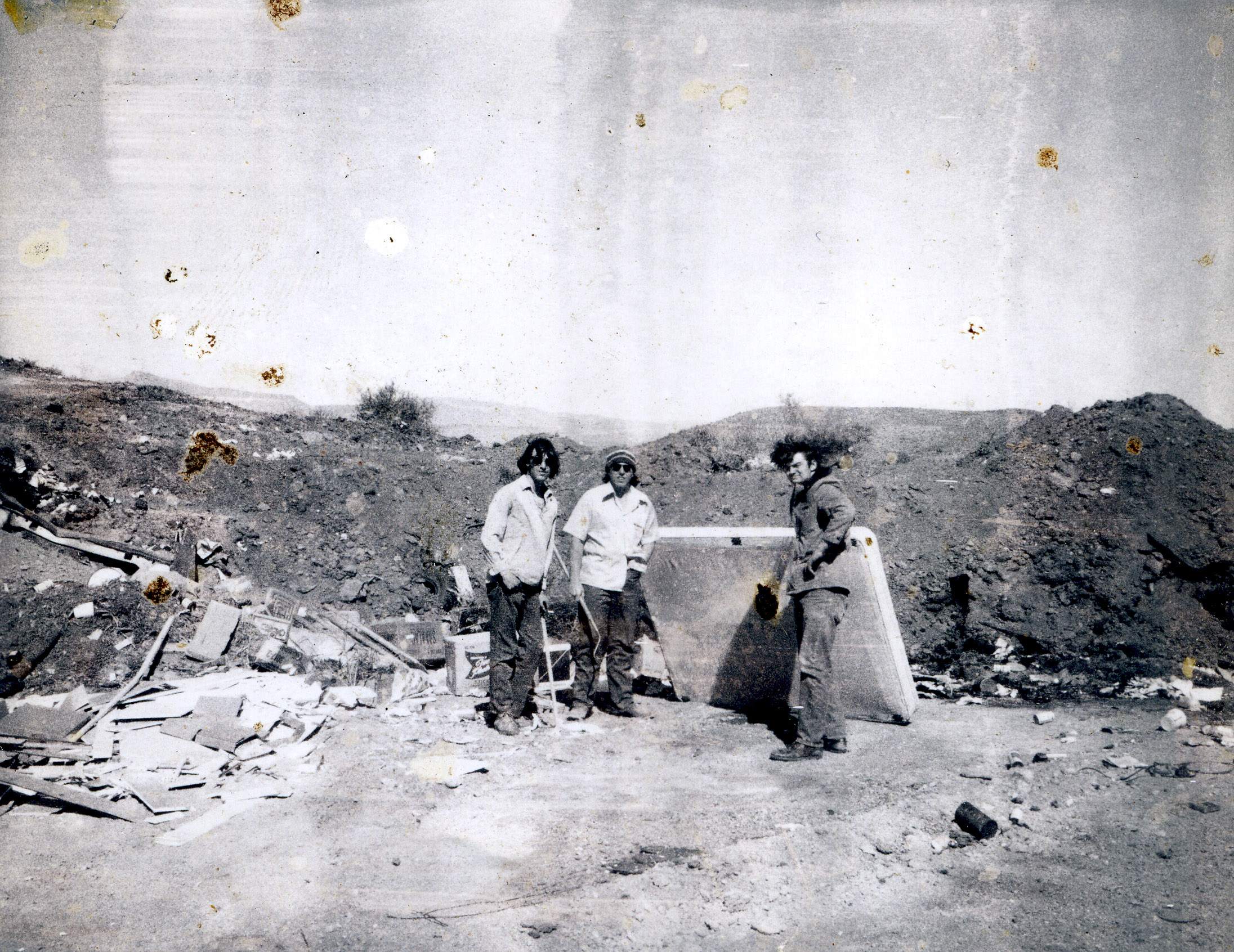 Brad Daniels, George Bradley, and Jim Higgs Turning trash at old Hillside Dump., ca April, 1974. Photo by Chris Baptista.