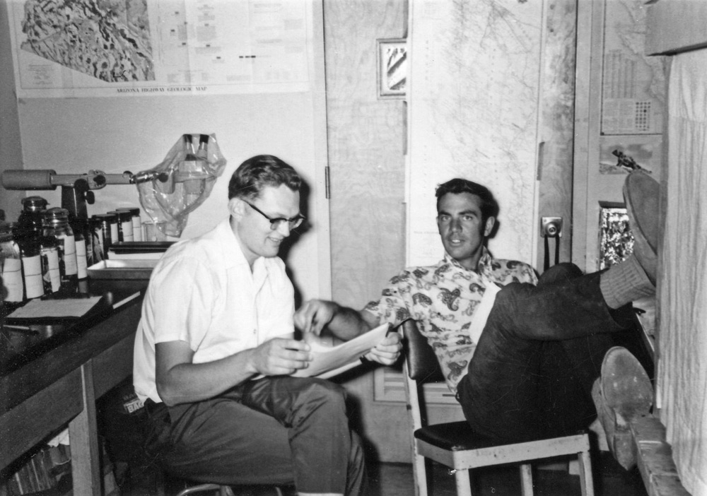 Jay Cole discussing a paper with Bob Bezy, photo by Oscar Soule.
