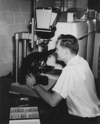 Jay Cole examining chromosome slides, ca 1867, University of Arizona, photo by Oscar Soule